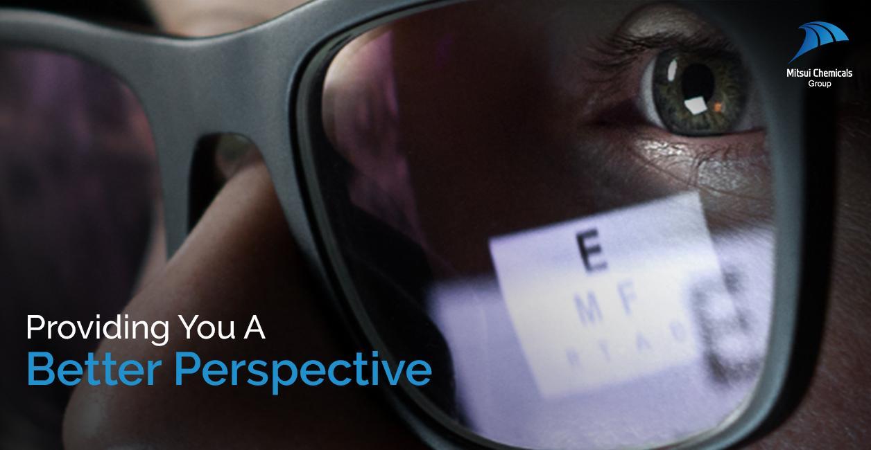 man wearing black specs looking at a screen 